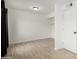 A clean bedroom space with neutral walls, wood-look floors and open closet space at 3646 N 67Th Ave # 20, Phoenix, AZ 85033