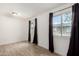 Bright bedroom with wood-look floors, two large windows and black out curtains at 3646 N 67Th Ave # 20, Phoenix, AZ 85033