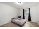 Simple bedroom with window and wood-look flooring at 3646 N 67Th Ave # 20, Phoenix, AZ 85033