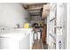 A laundry space with a washing machine, dryer, utility sink and storage shelving at 3646 N 67Th Ave # 20, Phoenix, AZ 85033