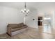 Bright living room featuring modern lighting and light-colored wood flooring at 3646 N 67Th Ave # 20, Phoenix, AZ 85033