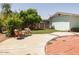 Inviting backyard featuring a spacious patio area, lush greenery, and mature trees for shade at 3741 W Davidson Ln, Phoenix, AZ 85051