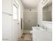 Bright bathroom featuring a shower with glass doors, a white vanity, and a linen closet at 3741 W Davidson Ln, Phoenix, AZ 85051