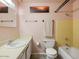 Traditional bathroom featuring a tiled bathtub, ample counter space, and a neutral color palette at 3741 W Davidson Ln, Phoenix, AZ 85051