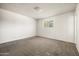 Bright bedroom with neutral carpet and a window providing natural light at 3741 W Davidson Ln, Phoenix, AZ 85051