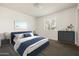Calming bedroom with a blue bed, matching nightstands, and serene decor at 3741 W Davidson Ln, Phoenix, AZ 85051