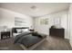 Cozy bedroom with a plush bed, side tables, and a bright window at 3741 W Davidson Ln, Phoenix, AZ 85051