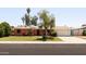 Charming single-story brick home featuring a well-maintained front yard, two-car garage, and mature landscaping at 3741 W Davidson Ln, Phoenix, AZ 85051