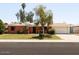 Charming single-story brick home featuring a well-manicured lawn and mature trees in a residential neighborhood at 3741 W Davidson Ln, Phoenix, AZ 85051