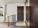 Foyer of home with stairway, dark front door, mirrored wall and decorative window at 3741 W Davidson Ln, Phoenix, AZ 85051