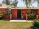 Close-up of the front door featuring red brick and a security gate in front of the entryway at 3741 W Davidson Ln, Phoenix, AZ 85051