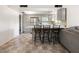 Kitchen with bar seating, stainless steel appliances, and easy access to the living room at 3741 W Davidson Ln, Phoenix, AZ 85051