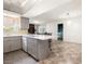 Well-lit kitchen featuring gray cabinets, white countertops, peninsula, and appliances at 3741 W Davidson Ln, Phoenix, AZ 85051