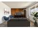 Inviting living room with a brown wood accent wall and a large window at 3741 W Davidson Ln, Phoenix, AZ 85051