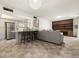 Open living room featuring an eat-in kitchen with stainless appliances, and built-in shelving at 3741 W Davidson Ln, Phoenix, AZ 85051