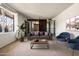Comfortable living room featuring a plush gray sofa, blue chairs, and ample natural light at 3741 W Davidson Ln, Phoenix, AZ 85051