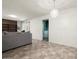 Bright living room featuring neutral walls, checkered flooring, and modern light fixture at 3741 W Davidson Ln, Phoenix, AZ 85051