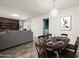Open-concept living and dining area with neutral tones and tiled floors at 3741 W Davidson Ln, Phoenix, AZ 85051