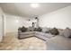 Comfortable living room featuring a gray sectional sofa and tile flooring at 3741 W Davidson Ln, Phoenix, AZ 85051