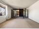 Spacious living room featuring carpet, railings, mirrored wall, and decorative window at 3741 W Davidson Ln, Phoenix, AZ 85051