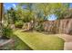 Green backyard showing lawn, mature trees and foliage in a private setting at 3926 E Lavender Ln, Phoenix, AZ 85044