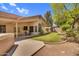 Lush backyard with patio, green grass, mature foliage and hot tub at 3926 E Lavender Ln, Phoenix, AZ 85044