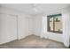 Bright bedroom with a window, ceiling fan and a large closet at 3926 E Lavender Ln, Phoenix, AZ 85044