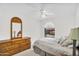 Bright bedroom featuring a ceiling fan, dresser and arched window at 3926 E Lavender Ln, Phoenix, AZ 85044