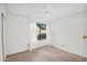 Bright bedroom with a ceiling fan, window and neutral carpet at 3926 E Lavender Ln, Phoenix, AZ 85044