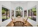 Charming dining area with arched window offering a view of the backyard at 3926 E Lavender Ln, Phoenix, AZ 85044