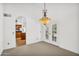 Bright dining room features an elegant light fixture and door leading to the outdoors at 3926 E Lavender Ln, Phoenix, AZ 85044