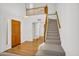 Inviting entryway features a wooden door, staircase leading to a loft, and hardwood floors flowing through the entry at 3926 E Lavender Ln, Phoenix, AZ 85044