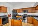 Modern kitchen features stainless appliances, granite counters and wood cabinets at 3926 E Lavender Ln, Phoenix, AZ 85044