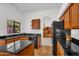Well-designed kitchen with dark granite countertops, wood cabinets, and stainless steel appliances at 3926 E Lavender Ln, Phoenix, AZ 85044