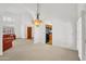 Open-concept living room with arched doorway, light-filled interior, neutral walls, and tile flooring at 3926 E Lavender Ln, Phoenix, AZ 85044