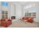 Spacious living room featuring a vaulted ceiling, large windows, a white fireplace, and comfortable seating at 3926 E Lavender Ln, Phoenix, AZ 85044