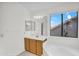A well-lit main bathroom showcases a vanity, soaking tub, and large window at 3926 E Lavender Ln, Phoenix, AZ 85044