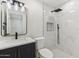 Modern bathroom with a walk-in shower, toilet, and a dark vanity with a marble countertop at 405 E Cornell Dr, Tempe, AZ 85283