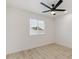 Bright bedroom featuring a modern ceiling fan and light-colored wood-look flooring at 405 E Cornell Dr, Tempe, AZ 85283