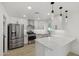 Modern kitchen featuring stainless steel appliances and sleek white cabinetry at 405 E Cornell Dr, Tempe, AZ 85283