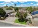 Aerial view of home with manicured lawn, mature trees, and a well-maintained front yard and driveway at 420 S Dodge Dr, Chandler, AZ 85225