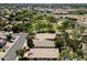 Wide aerial shot showcases the neighborhood, mature trees, and home rooftops, creating a peaceful environment at 420 S Dodge Dr, Chandler, AZ 85225
