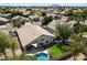 Aerial view of home, showcasing pool, covered patio, landscaped yard, and neighborhood at 420 S Dodge Dr, Chandler, AZ 85225