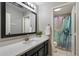 Neat bathroom featuring a modern vanity, decorative mirror, and a shower/tub combination, designed for convenience at 420 S Dodge Dr, Chandler, AZ 85225