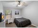 Cozy bedroom with a ceiling fan, window with blinds, and a calming gray color scheme, ideal for relaxation at 420 S Dodge Dr, Chandler, AZ 85225