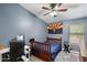 Comfortable bedroom with a ceiling fan, window with blinds, and a desk, ideal for study and rest at 420 S Dodge Dr, Chandler, AZ 85225