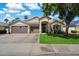 Charming single-story home featuring a three-car garage and a well-manicured front yard with vibrant green grass at 420 S Dodge Dr, Chandler, AZ 85225
