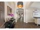 Inviting hallway featuring wood floors, neutral paint, art display and statement lighting fixture, creating a warm welcome at 420 S Dodge Dr, Chandler, AZ 85225