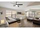Spacious living room with sleek wood floors, a wet bar, entertainment setup and ample natural light from large windows at 420 S Dodge Dr, Chandler, AZ 85225