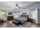 Serene main bedroom with neutral tones, wood floors, ceiling fan, and large windows offering a relaxing retreat at 420 S Dodge Dr, Chandler, AZ 85225